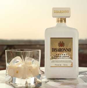 A bottle of Disaronno Velvet and a glass of Disaronno Velvet over ice A bottle of Disaronno Velvet and a glass of Disaronno Velvet over ice