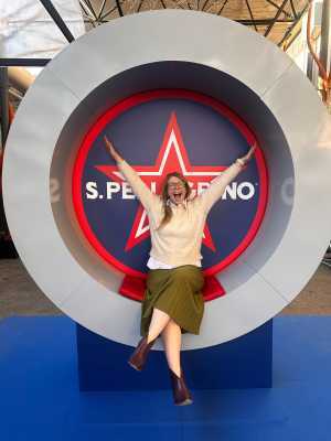 The S. Pellegrino Young Chef Competition | Writer Caroline Aksich poses in front of a sign in Milan at the The S. Pellegrino Young Chef Competition