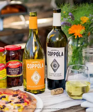 Coppola wines with a glass, a freshly baked pizza and condiments Coppola wines with a glass, a freshly baked pizza and condiments