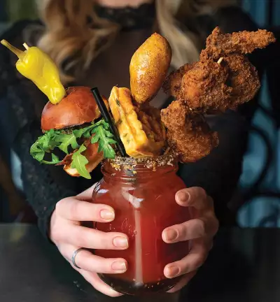 The history of the caesar cocktail | An over the top caesar stacked with a slider, a waffle and chicken wings The history of the caesar cocktail | An over the top caesar stacked with a slider, a waffle and chicken wings
