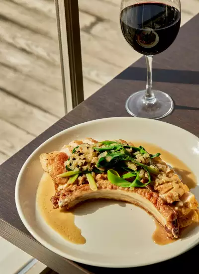 Heritage Pork Chop and a glass of wine at Lighthouse45 restaurant at Rawley Resort in Port Severn
