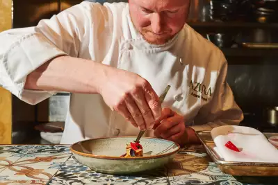 Chef Adam Ryan prepares a dish at tasting menu restaurant Azura