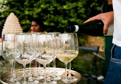 Anna Tasca Lanza Cooking School, Sicily | Guests at Anna Tasca Lanza Cooking School sip glasses from the on-site winery