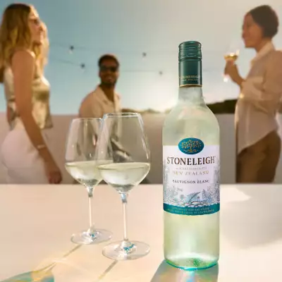 A bottle of Stoneleigh with two glasses at a party