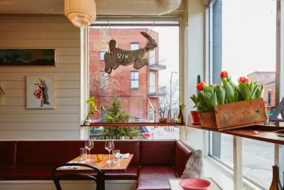 A rabbit sign hangs above a dining table at Vin Mon Lapin in Montr&eacute;al