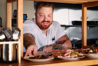 Fat Rabbit | Executive chef Zach Smith hands a dish through the pass at Fat Rabbit