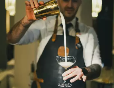 Toronto Cocktail Festival | A bartender pours a cocktail from a height