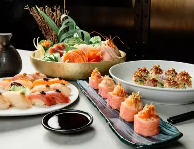 Black + Blue Steakhouse | A bowl of sashimi, sushi and seafood sits on a table at Black + Blue Steakhouse