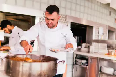 Don Alfonso's urban farm at Casa Loma | Executive chef Davide Ciavattella stirs a pot of tomato sauce