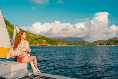Relax in St. Kitts | A woman on a yacht looks out to sea in St. Kitts Relax in St. Kitts | A woman on a yacht looks out to sea in St. Kitts