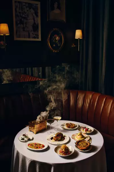 Punch Toronto | A shot of a table at Punch, featuring Beef Wellington, Scotch Egg and Mumbai Chat-Slaw