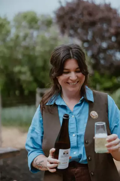 Down Home in Markdale | Co-owner Hannah Harradine pours a glass of local cider at Down Home