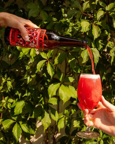 Bellwoods Jelly King | A hand pours a bottle of Jelly King Montmorency Cherry at Bellwoods Brewery on Ossington