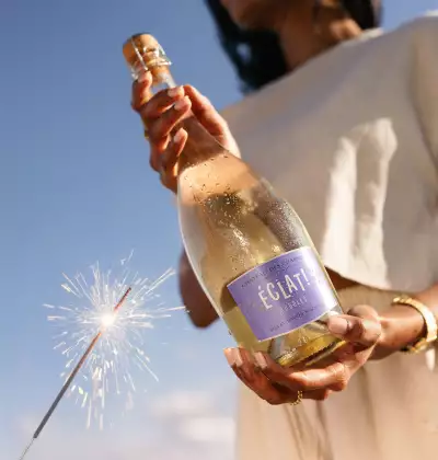 Summer drinks | A hand holds a bottle of Chateau Des Charmes Eclat Bubbles with a sparkler in shot Summer drinks | A hand holds a bottle of Chateau Des Charmes Eclat Bubbles with a sparkler in shot