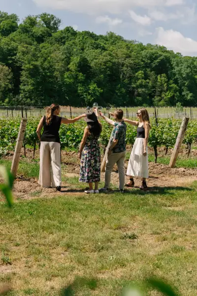 Mason Vineyard | A group cheers in front of the vineyards at Mason Vineyard Mason Vineyard | A group cheers in front of the vineyards at Mason Vineyard