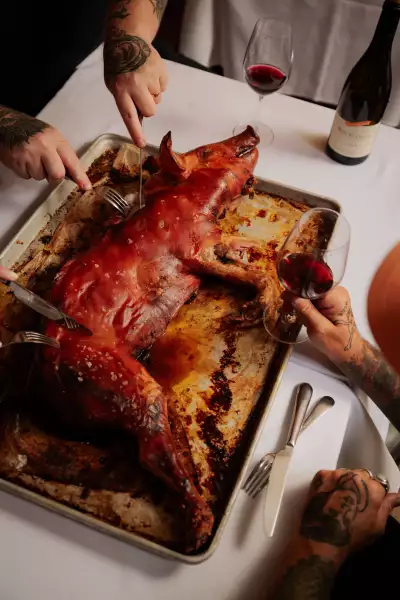 Casa Rubia | Guests dive into the suckling pig, served whole