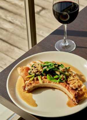 Heritage Pork Chop and a glass of wine at Lighthouse45 restaurant at Rawley Resort in Port Severn Heritage Pork Chop and a glass of wine at Lighthouse45 restaurant at Rawley Resort in Port Severn