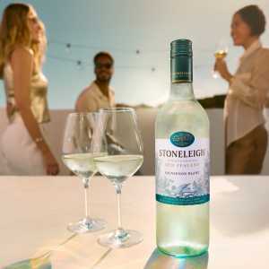 A bottle of Stoneleigh with two glasses at a party A bottle of Stoneleigh with two glasses at a party