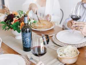 Thirty Bench wine on a table spread with food Thirty Bench wine on a table spread with food