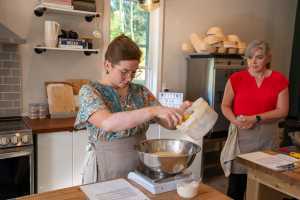 Support local with Feast On® | A baker measures ingredients on a scale in a kitchen