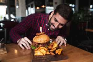 Canada Beef | A man gazes longingly at his beef burger Canada Beef | A man gazes longingly at his beef burger