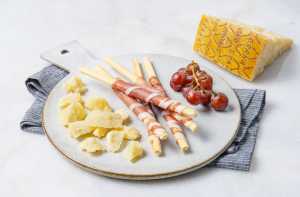 Flavours of Europe with Prosciutto di Parma PDO and Grana Padano PDO | Grapes, Parma ham wrapped around breadsticks and Italian cheese on a cheeseboard