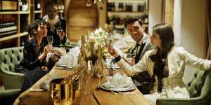 Bottega Gold | A group of friends enjoy Bottega Gold over a dinner table