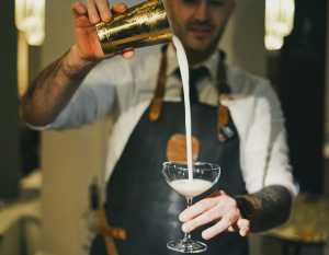 Toronto Cocktail Festival | A bartender pours a cocktail from a height