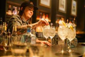 Toronto Cocktail Festival | Bartender Kaitlyn Stewart places a lemon garnish on a cocktail