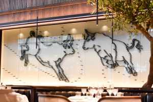 Black + Blue Steakhouse | A bull mural made entirely from steak knives displays at Black + Blue Toronto Black + Blue Steakhouse | A bull mural made entirely from steak knives displays at Black + Blue Toronto