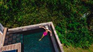 Relax in St. Kitts | A man in pink trunks relaxes in a pool in St. Kitts