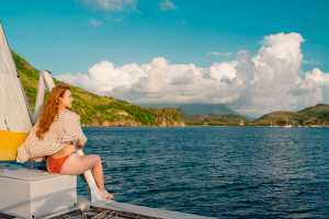 Relax in St. Kitts | A woman on a yacht looks out to sea in St. Kitts