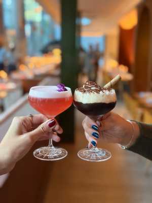Oretta Downtown | Two hands cheers with cocktails, including the espresso martini, at Oretta Downtown on Front Street