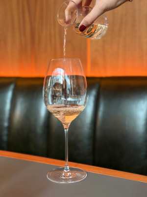 Oretta Downtown | A hand pours a glass of wine into a glass at Oretta Downtown
