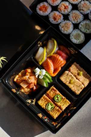 Neighbourhood Gems on DoorDash | A box of takeout from Hello Nori, featuring aburi sushi and sashimi
