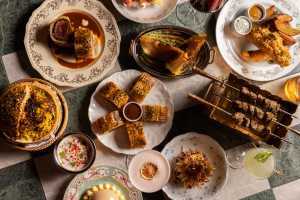 Punch Toronto | A shot of a table shot at Punch, featuring Beef Wellington, Scotch Egg and Mumbai Chat-Slaw