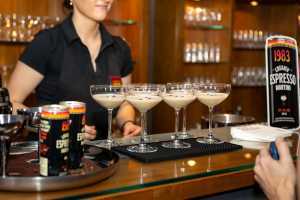 Yes Shef | A bartender stands behind a tray of espresso martinis at a Yes Shef event