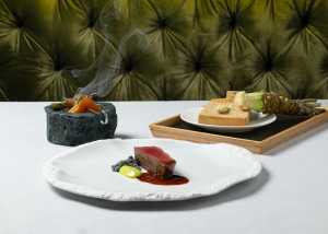 DaNico | Three dishes, including a meat plate, sit on a white tablecloth at DaNico in Little Italy