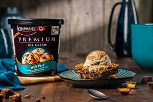 Chapman's Ice Cream | A tub of Wolf Pass Ice Cream, with chocolate peanut butter cups and brownie pieces in vanilla ice cream with swirls of peanut butter