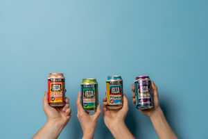 iOTA non-alcoholic beer | Three hands hold cans of iOTA non-alcoholic beer lineup from Phillips Brewing