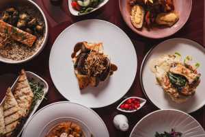 Deauville Club | An overhead shot of collection of French, Italian and Spanish-inspired dishes at Deauville Club inside the Revery Hotel