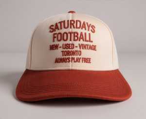 FIFA Toronto | A red and white hat thats reads 'Saturdays Football New-Used-Vintage Toronto Always Plays Free' available at Ace Hotel