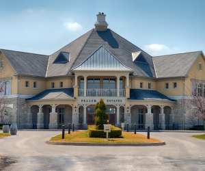 Niagara Wineries | Large yellow building at entrance of Peller Estates