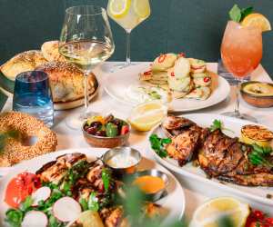 Best new Toronto restaurants | A spread of drinks and dishes at Meláni Greek Restaurant