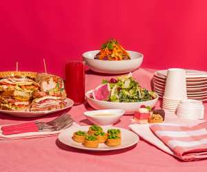 Dishes from O&B against a pink backdrop