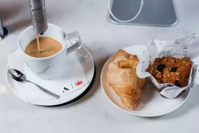 Coffee, a croissant and a muffin inside the Aspire | Air Canada Caf&eacute; at Billy Bishop Toronto City Airport