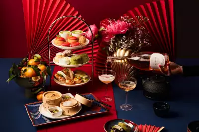 A cake stand of treats, bamboo steamer baskets, tea and sparkling wine at Holts Café Lunar New Year Afternoon Tea