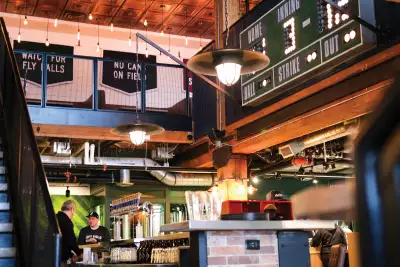 Left Field Brewery, Liberty Village, Toronto | The scoreboard and seating inside Left Field Brewery