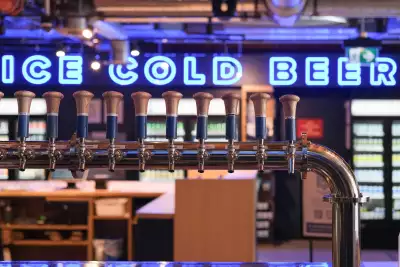 Left Field Brewery, Liberty Village, Toronto | Taps and an "Ice cold beer" sign inside Left Field Brewery