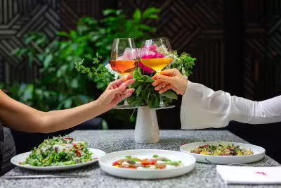 People cheers wine glasses on the patio at Sofia Restaurant in Yorkville, Toronto